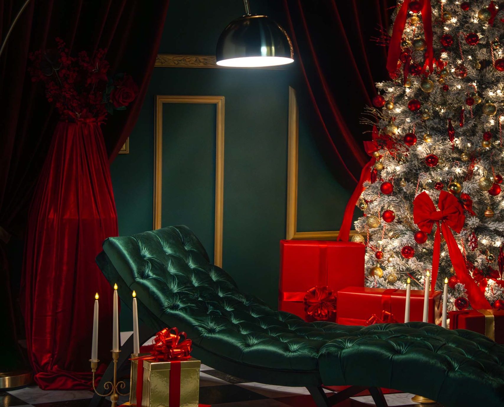 Red Muse holiday set at Hadaki Studios featuring an emerald green chaise lounge, Christmas tree with red and gold décor, velvet drapery, candles, and festive gifts—ideal for holiday photoshoots in Toronto.